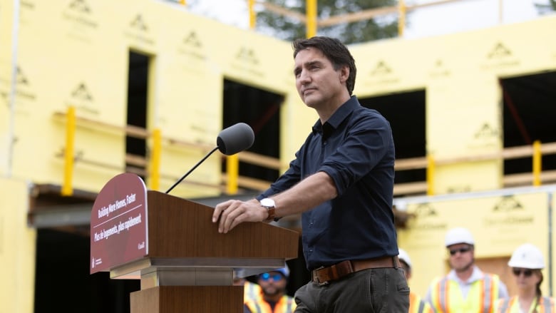 Justin Trudeau stands at a podium