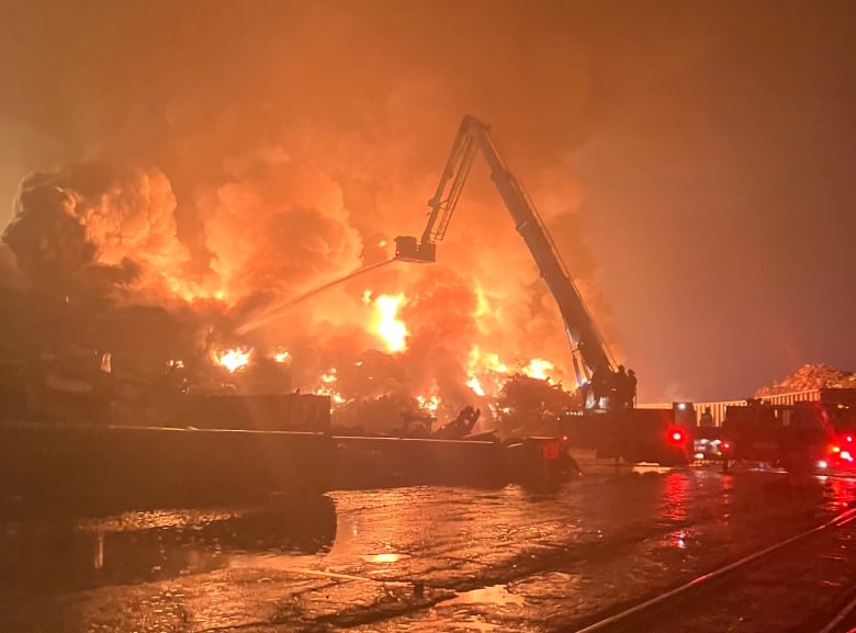 Nighttime image of a large fire, billowing smoke