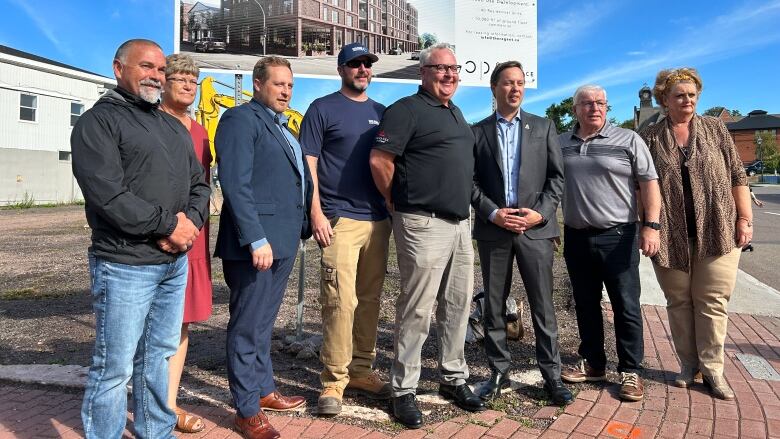 Developer Paul Jenkins, fourth from the right in a black shirt, stands with Summerside Mayor Dan Kutcher, third from the right, and other members of Summerside council on Friday. 