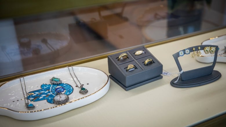 Rings, necklaces and other items are seen in a shop's display case.