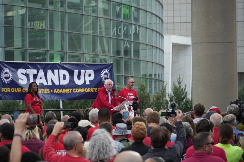 A crowd of people watching a speech.