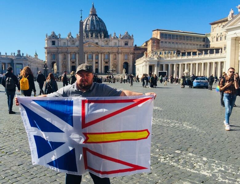 Gemma Hickey is pictured holding up a Newfoundland flag in front of the Vatican.