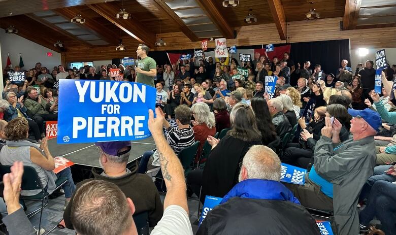 Pierre Poilievre speaks to a room full of supporters in Whitehorse.