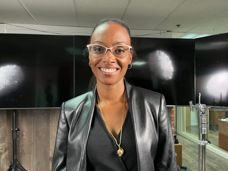 A woman smiles at the camera. 