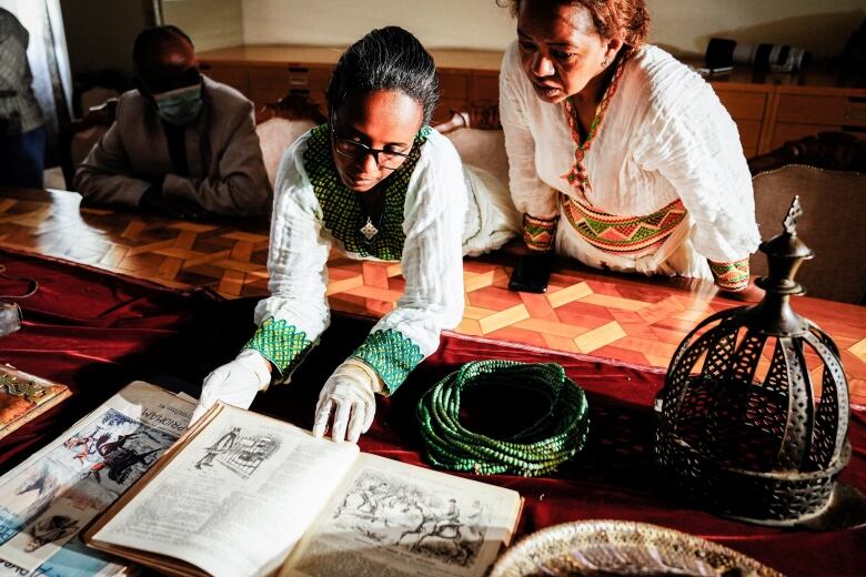 Staff look at recovered items to be on display at the National Museum as Ethiopia hailed the return of precious artefacts looted by British soldiers more than 150 years ago in Addis Ababa, Ethiopia, on November 20, 2021, two months after they were formally handed over at a ceremony in London. 