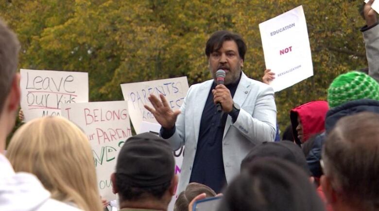 A man addressing a crowd.