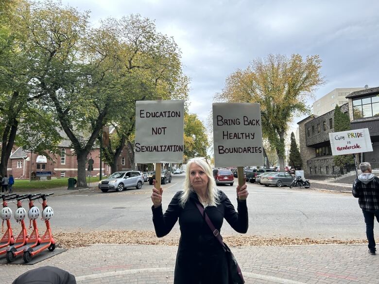 A woman holding signs.