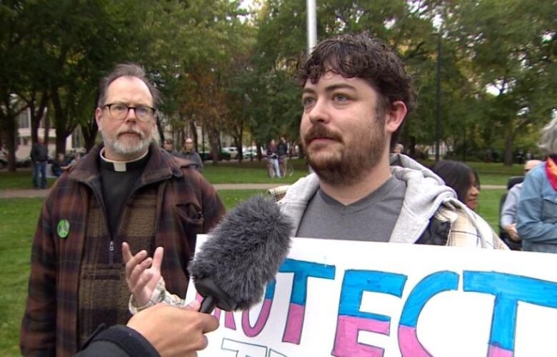 A man holding a poster.