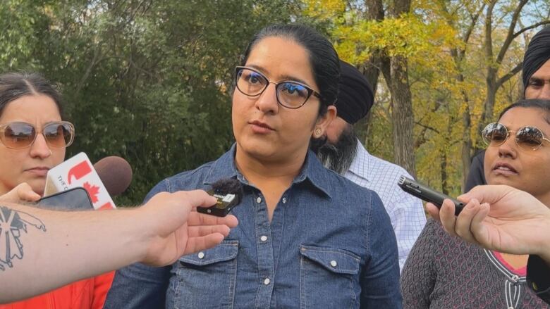 A woman in a denim shirt.