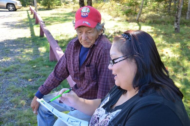  Pictured here is Stephen Julian next to a women sitting on a bench in the woods.  