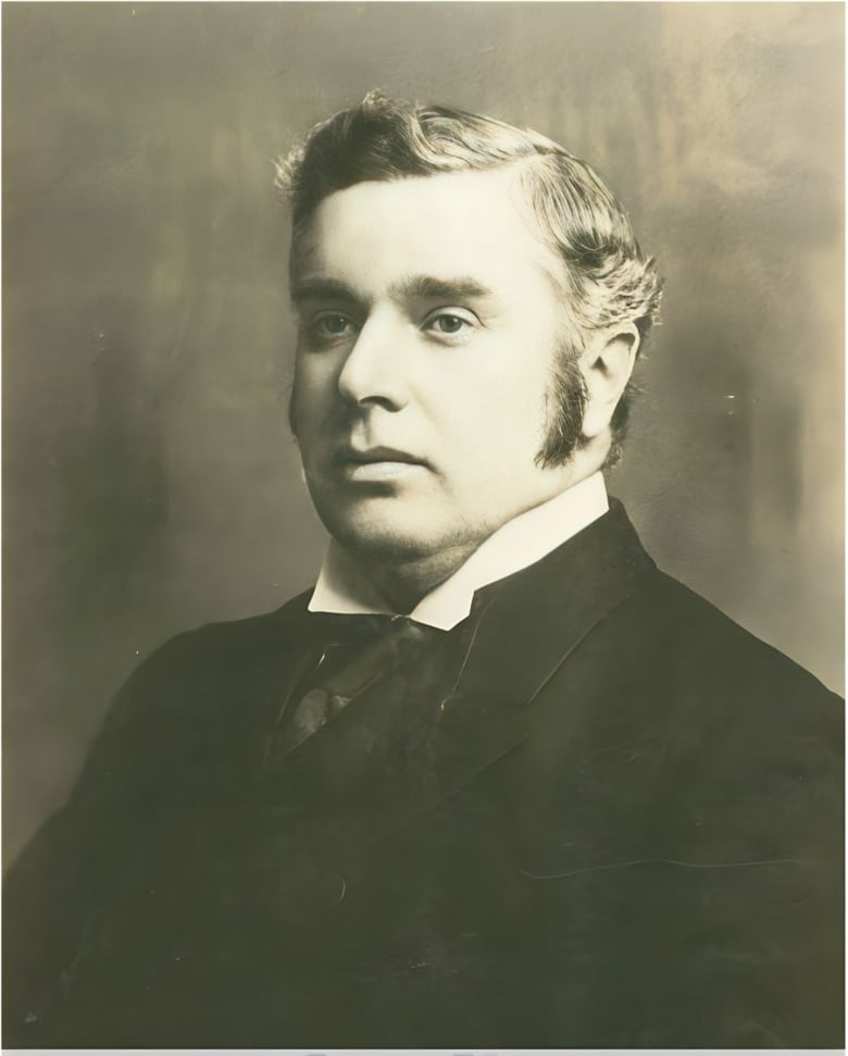 A monochrome photograph of a man in Victorian dress