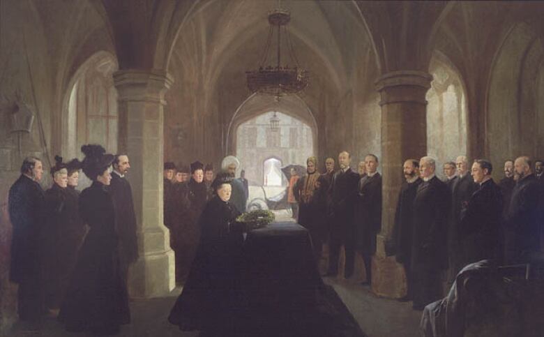 Queen Victoria laying a wreath on a black draped coffin