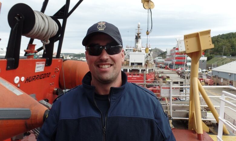 Man standing atop a ship.