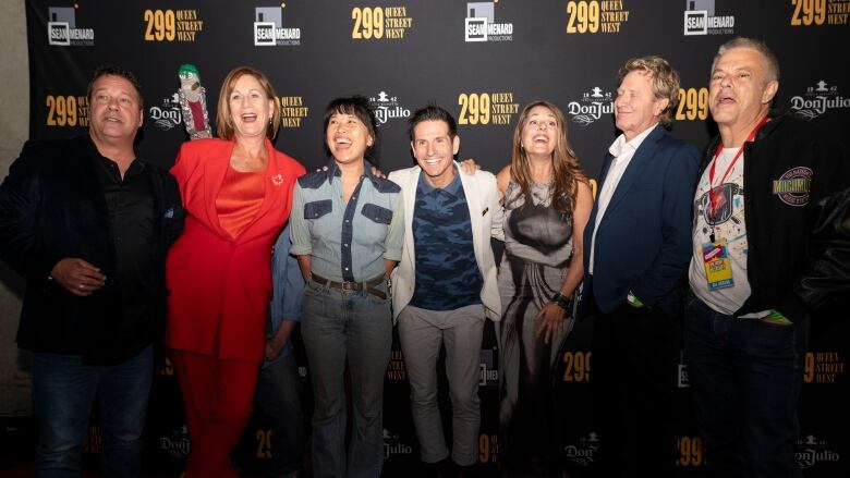 Seven former MuchMusic people pose on the red carpet.