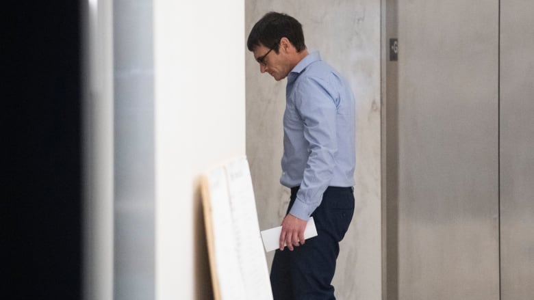 Cameron Ortis, a senior intelligence official at the RCMP, walks into his lawyer's office building in Ottawa after being granted bail, Tuesday, Oct. 22, 2019. Ortis is accused on charges of violating the Security of Information Act and breach of trust for allegedly disclosing secrets to an unknown recipient. 