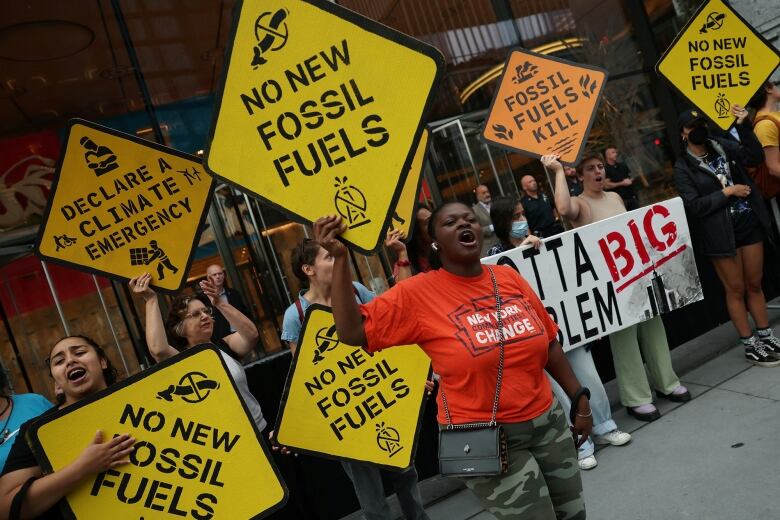 Climate activists protest fossil fuel use.