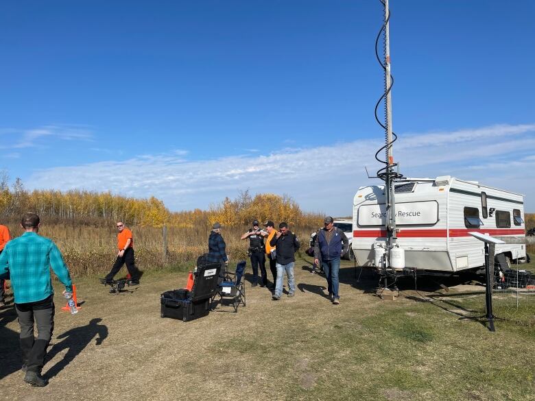 Several people near a trailer marked Search and Rescue.