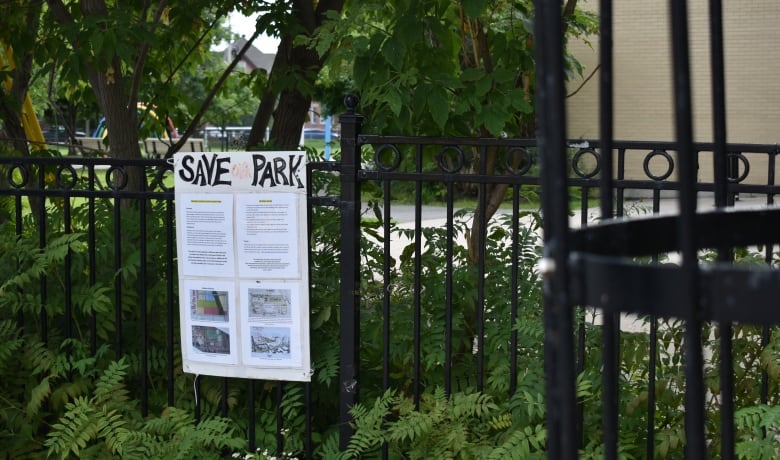 A sign on a park fence headlined 'Save our Park.'