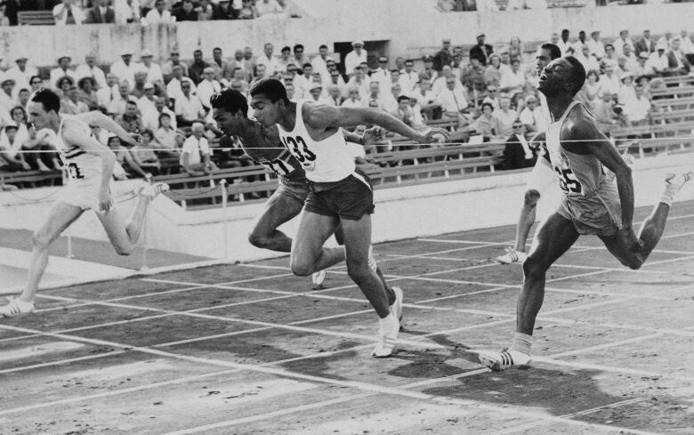 Harry Jerome, 133, of Canada hits the tape to win the fourth heat of the men's 100 meter dash quarterfinals at the Olympics in Rome, Aug 31, 1960. Finishing second is Britain's Peter Radford, left, and finishing third is Kenya's S.S. Antao, right. Jerome's time was 10.4. (AP Photo)