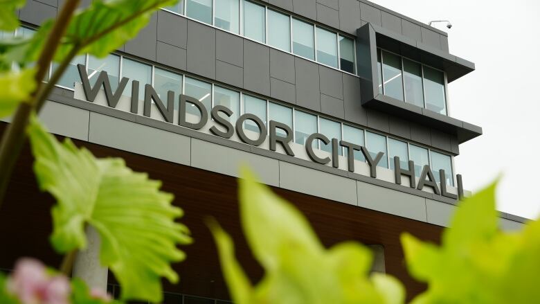 A building with the words Windsor City Hall on a sign framed by leaves.