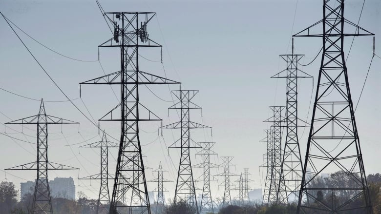 High-voltage power lines are seen over a golf course.