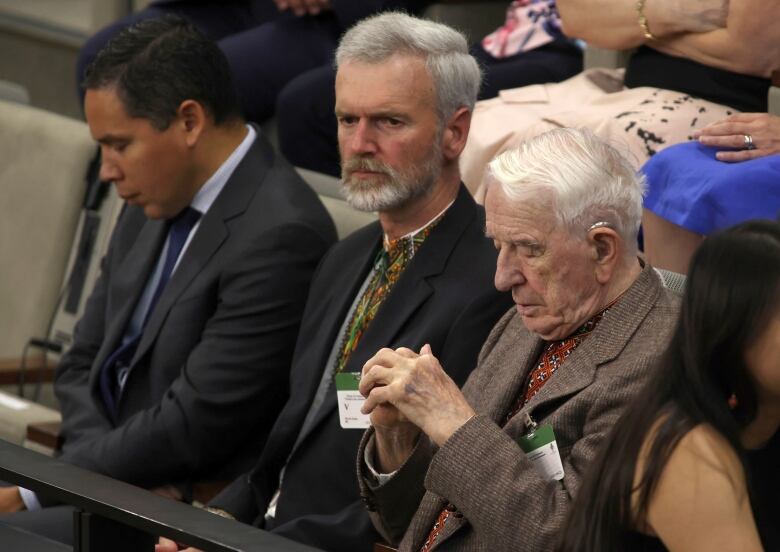 An elderly man sits in the gallery in the Canadian House of Commons.