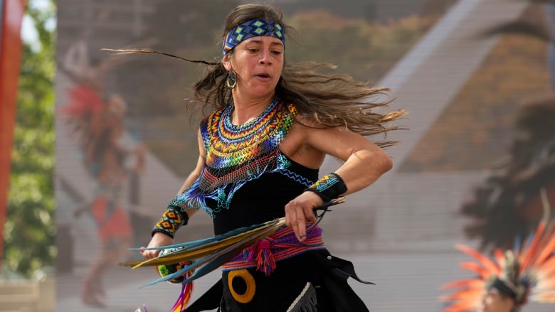 A woman on stage during a performance at the 2023 Indigenous Legacy Gathering at Nathan Phillips Square in Toronto.