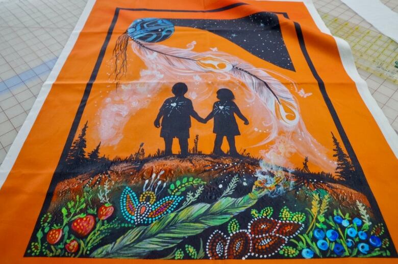 A large, orange quilt panel that features two black silhouettes of two children under a large white feather.