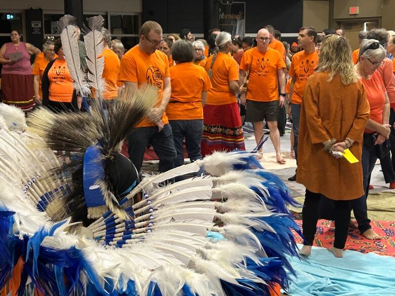 The blankets were slowly removed and the crowd got more condensed to represent the loss of land sue to colonization.