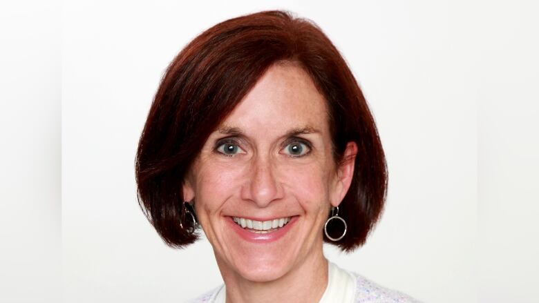 A smiling woman with dark hair and a short bob hairstyle.