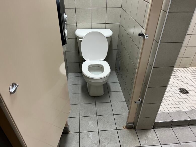 A toilet in a stall in a public washroom