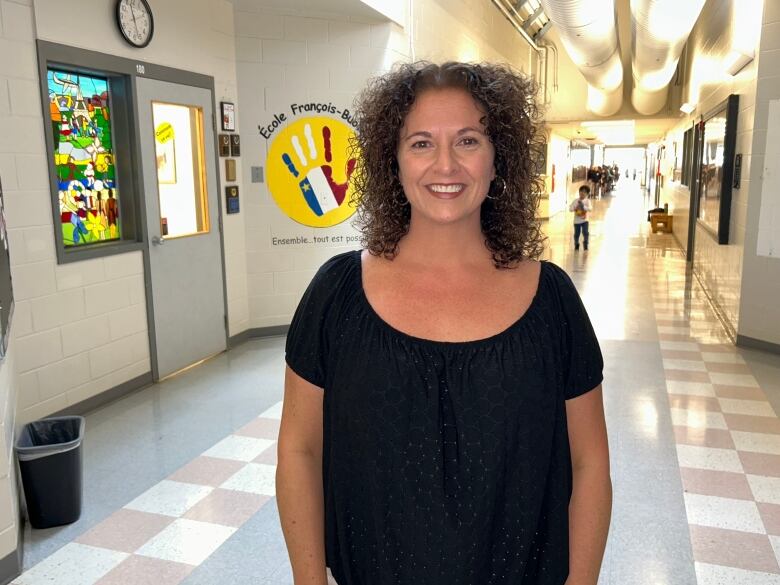 Principal Isabelle Savoie-Jamieson stands in school hallway. 