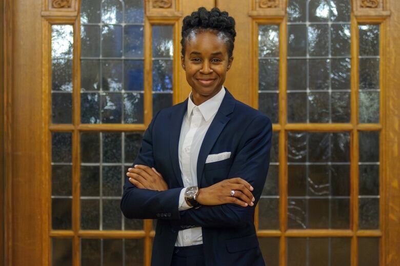 A politician in a navy blue blazer smiles for the camera.