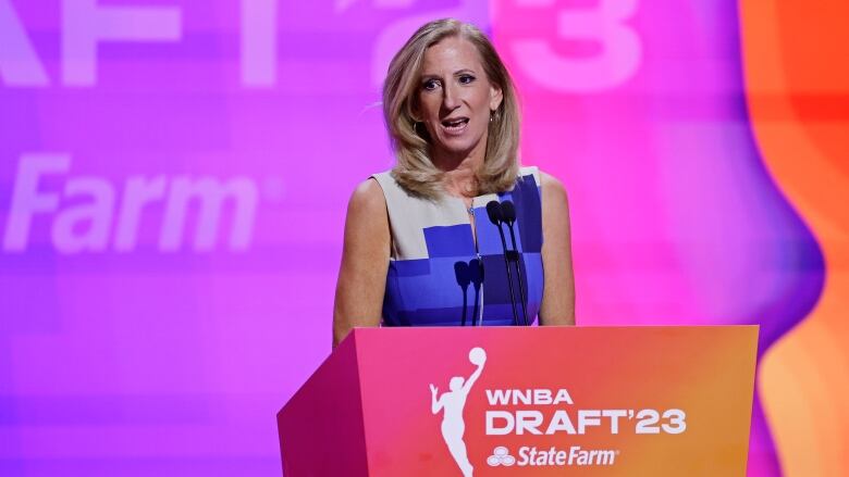 A woman speaks at a podium.