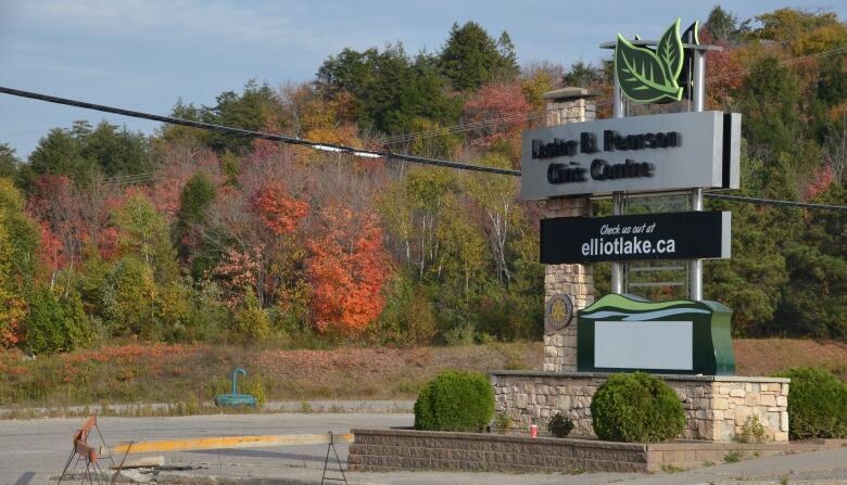 A sign reading 'Lester B. Pearson Civic Centre' stands in front of an empty lot  