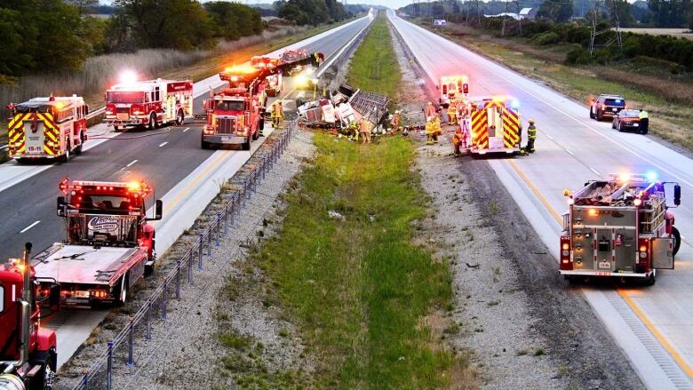 A stretch of Highway 401 in Chatham-Kent is shown, with several emergency vehicles, following a single rollover crash involving a transport truck hauling livestock.