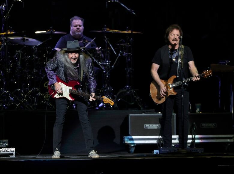 Two guitarists from The Doobie Brothers are shown on stage at a 2021 concert in Nashville.