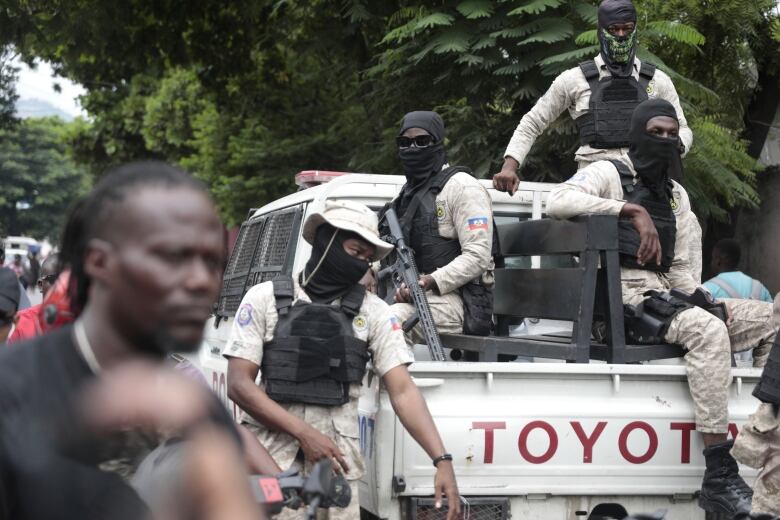 Police stand guard as as former Haitian president Michel Martelly leaves after appearing before the investigating judge in the case of the assassination of Haitian President Jovenel Moise in Port-au-Prince, Haiti on Oct. 3, 2023.