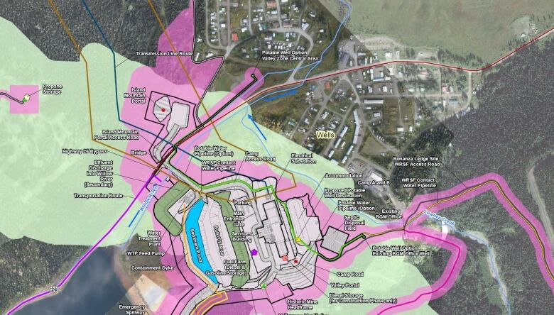 A satellite map is overlaid with buiding plans in a rural forested area next to a small village.