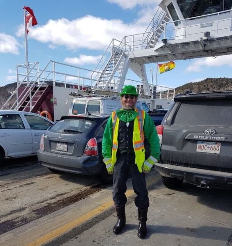 A deckhand on a ferry in a full leprechaun outfit. 