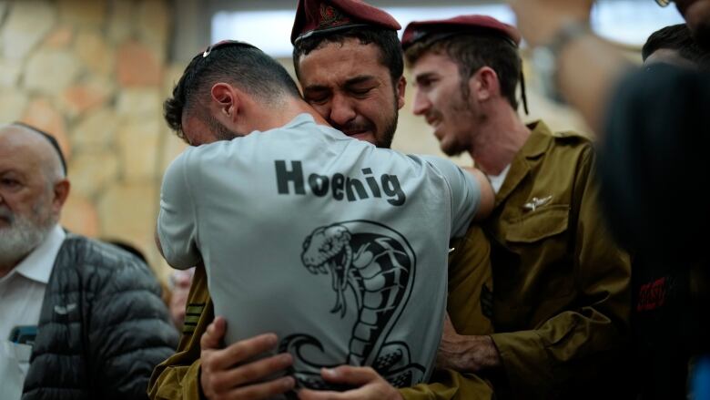 Mourners react during the funeral of Israeli soldier Benjamin Loeb, a dual Israeli-French citizen, in Jerusalem, Tuesday, Oct. 10, 2023. Loeb was killed on Saturday as the militant Hamas rulers of the Gaza Strip carried out an unprecedented, multi-front attack on Israel.