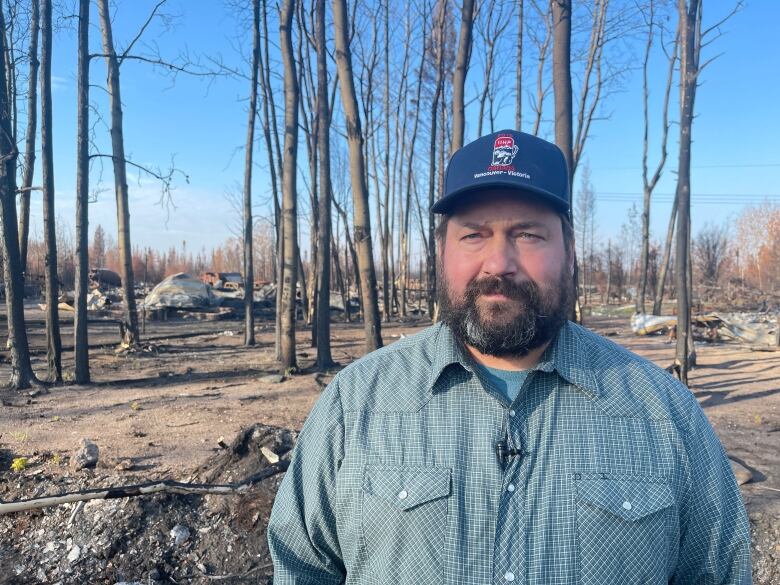 Man in burnt forest.