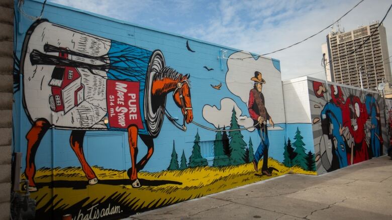 A mural featuring a horse walking inside a can of maple syrup