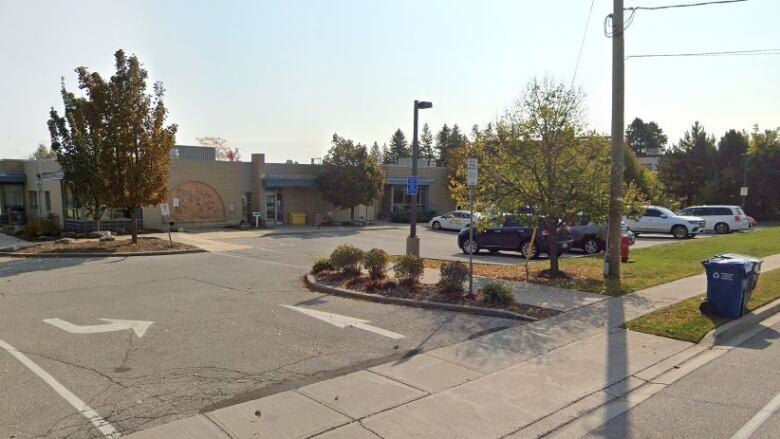 A parking lot with a building in the background.