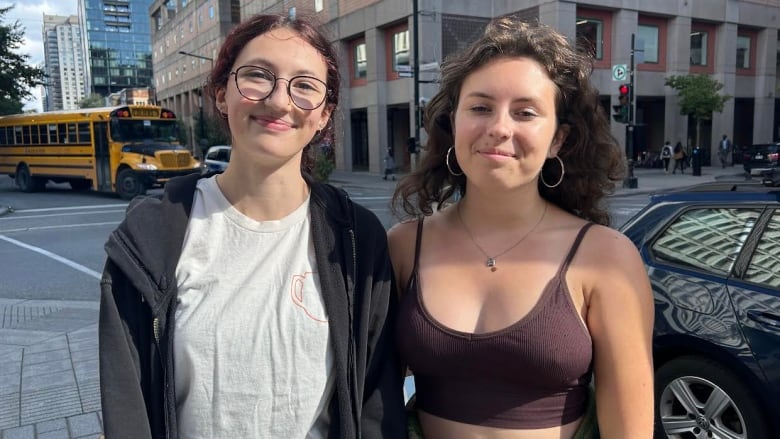 Two women stand in the steet