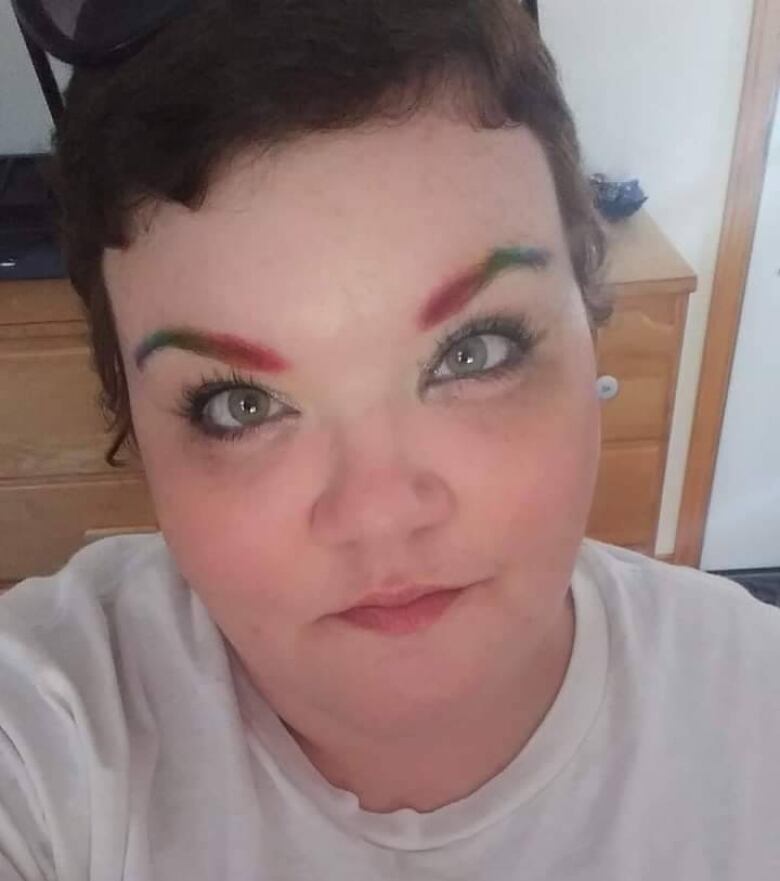 A woman with colourful eyebrows.