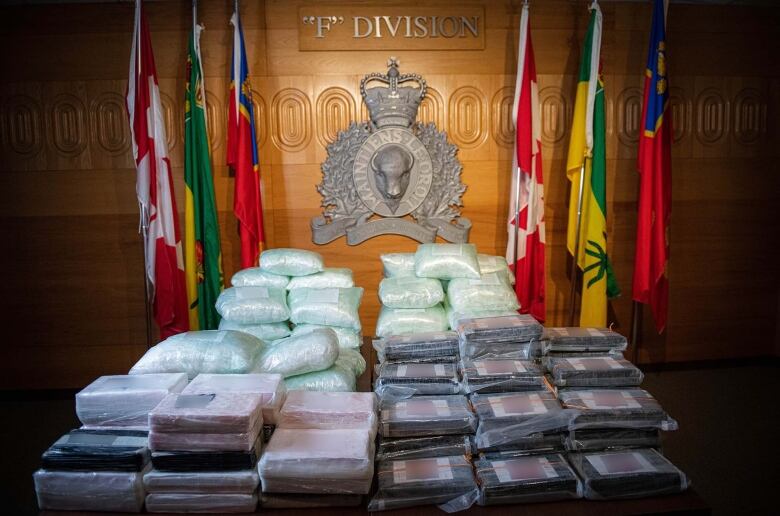 Dozens of bags of drugs laid on a table for show