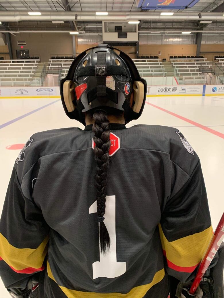 Elliana McKay on the ice with her long braid showing under her helmet