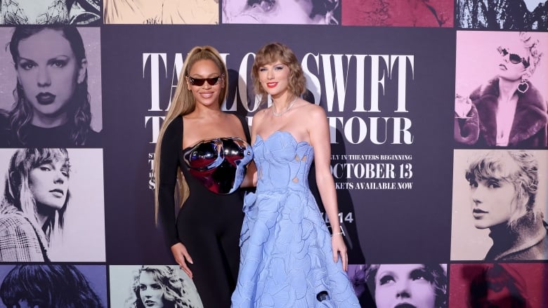 A woman in a chrome corset, left, and a woman in a blue ballgown are pictured during a red carpet event.