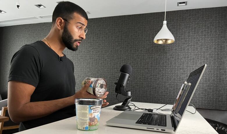 Neal Chauhan sitting at his computer working on a TikTok video. 